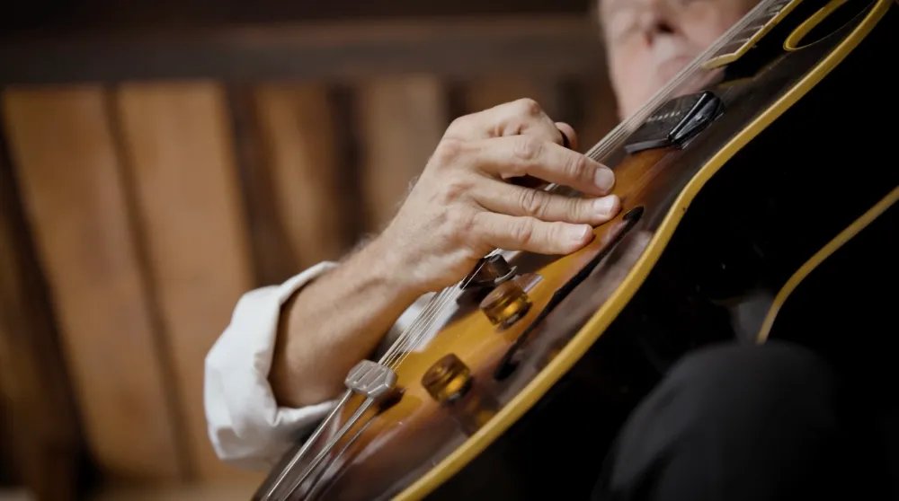Closeup of Jimmy playing guitar